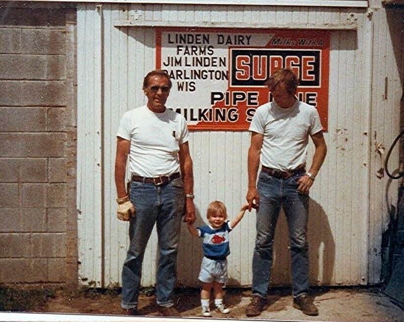 Jared as a toddler with his grandfather and father outside the barn at Linden Dairy Farms in Darlington, Wisconsin