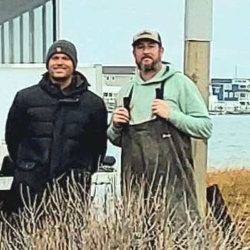 Jared in waders with a fellow volunteer during an osprey nesting platform install